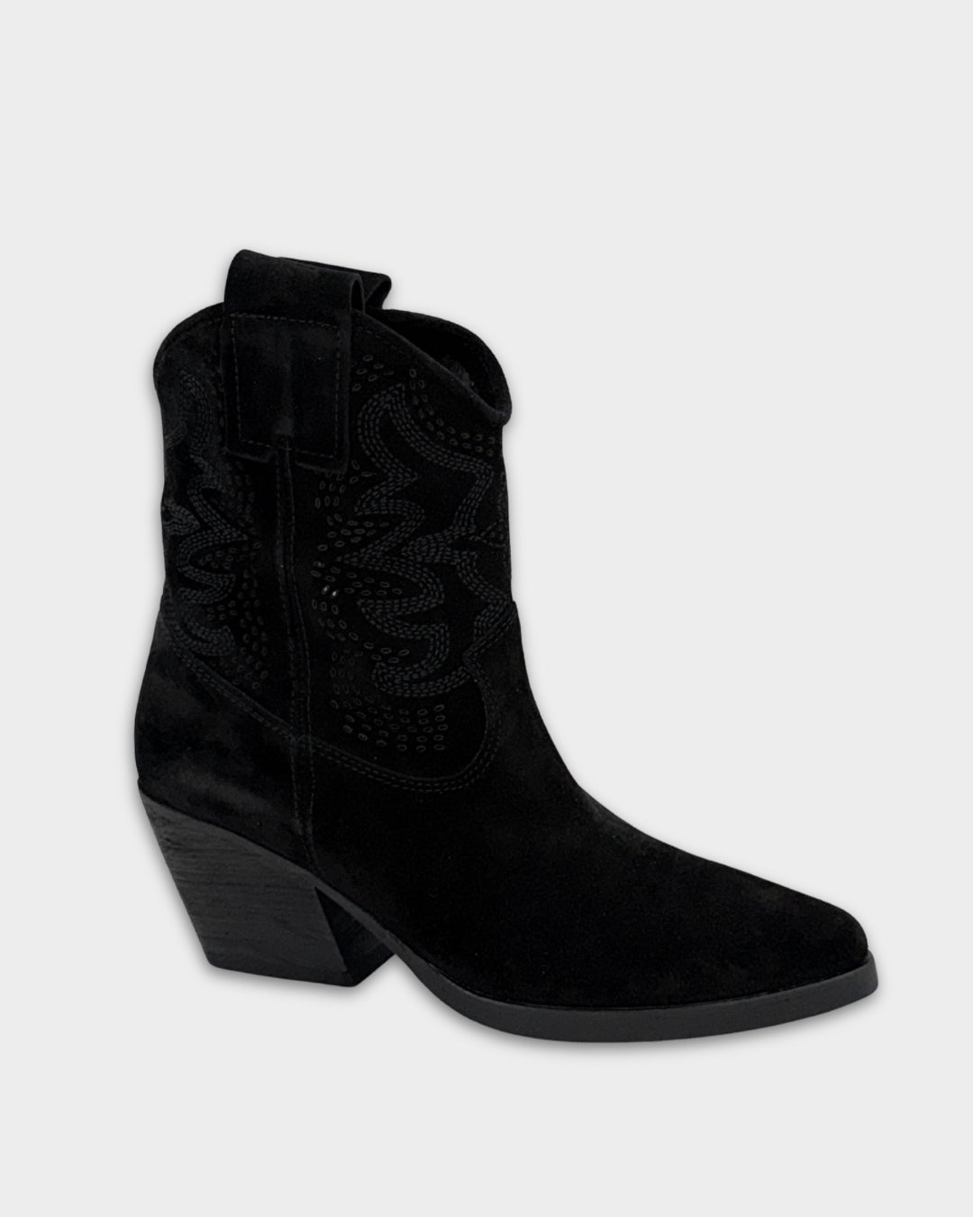 Black cowboy boot on a light gray background
