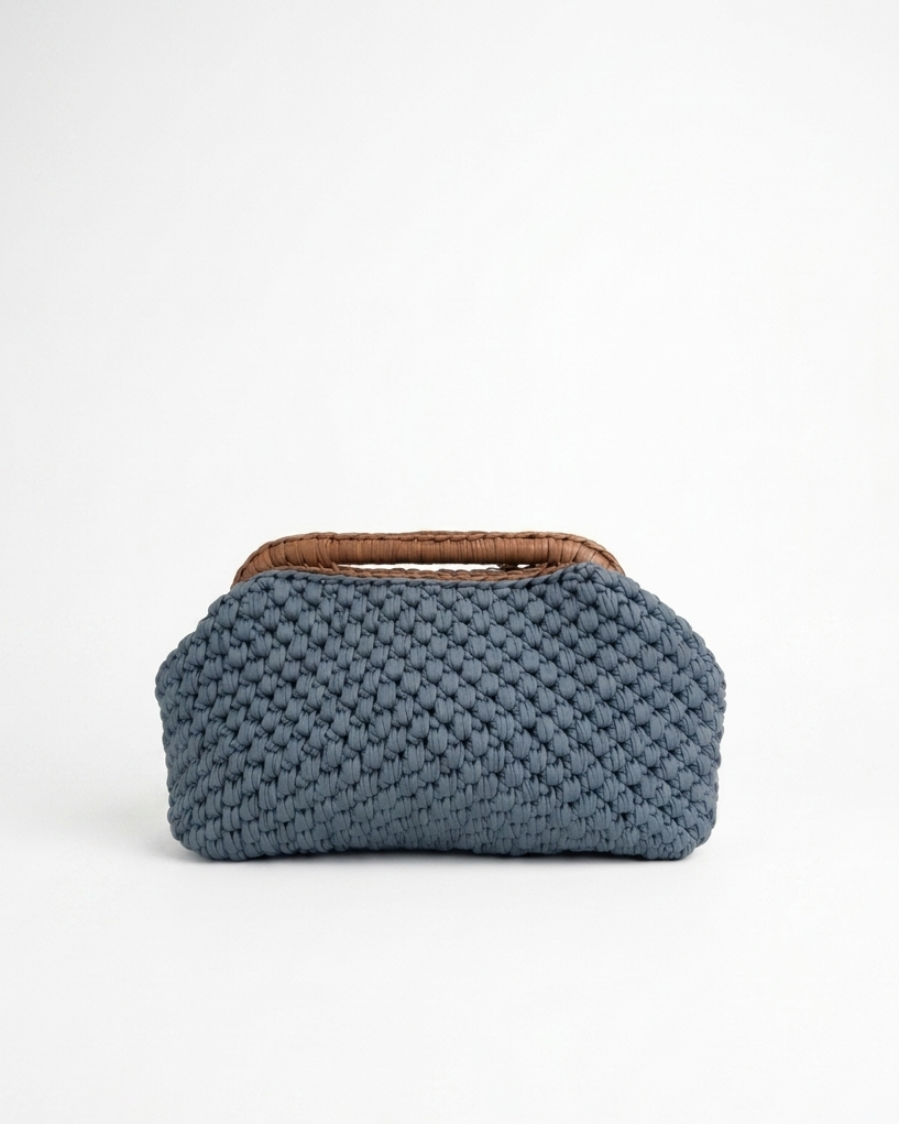 Blue woven clutch bag with brown handle on a white background