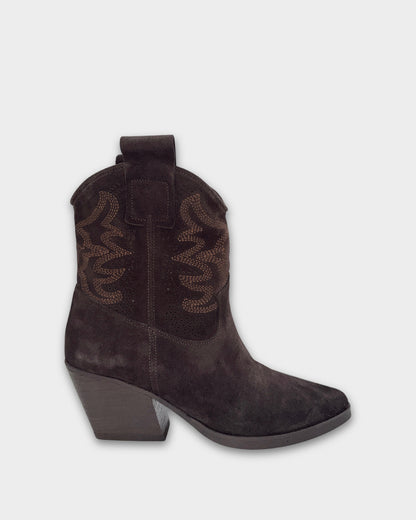 Dark brown suede cowboy boot on a light gray background