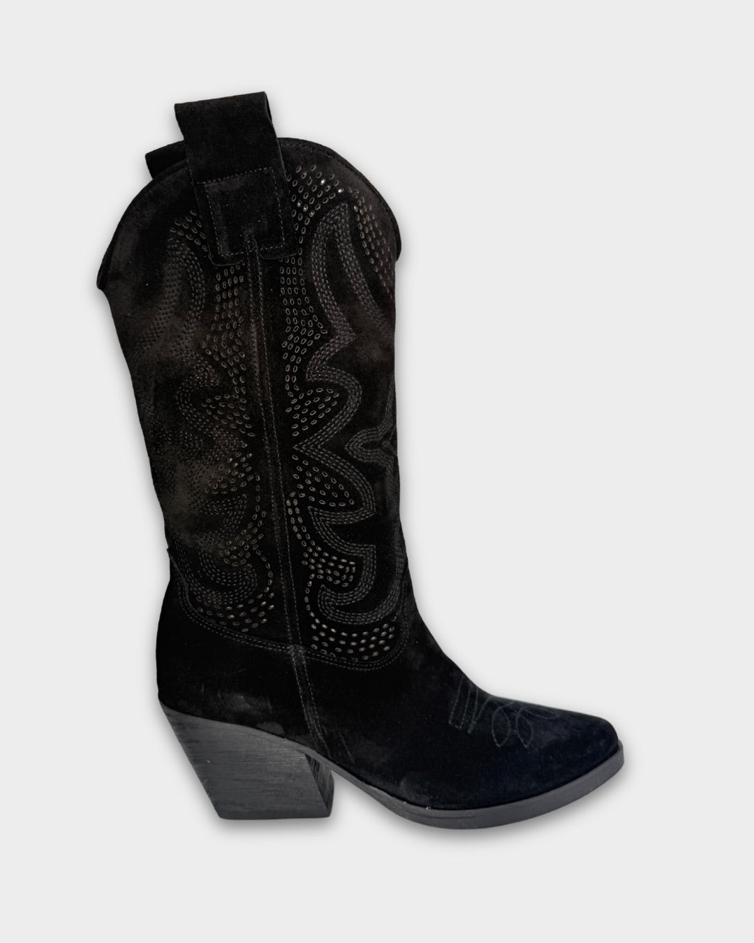 Black cowboy boot with decorative patterns and laser cur on a light gray background