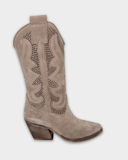 Brown cowboy boot with cut-out design on a light gray background